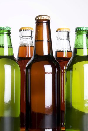 A close up of several different types of beer bottles.